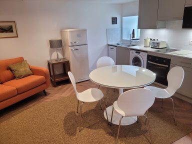 open plan, family space with kitchen, dining area and sofa.